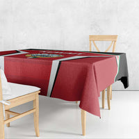 Red Kuwait Cricket tablecloth spread over bench table with black-and-white stripe panel
