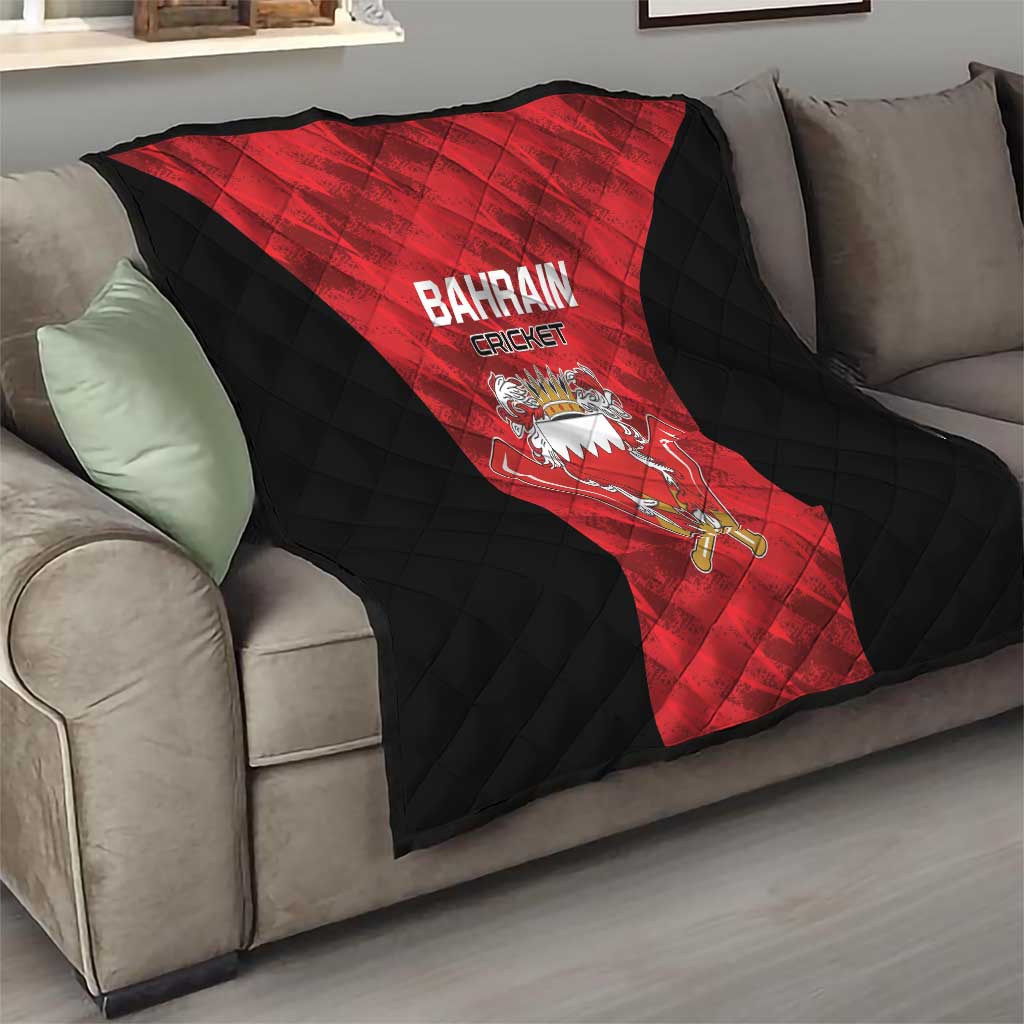 Bahrain cricket quilt on couch, red and black quilted design with crest and 'BAHRAIN CRICKET'