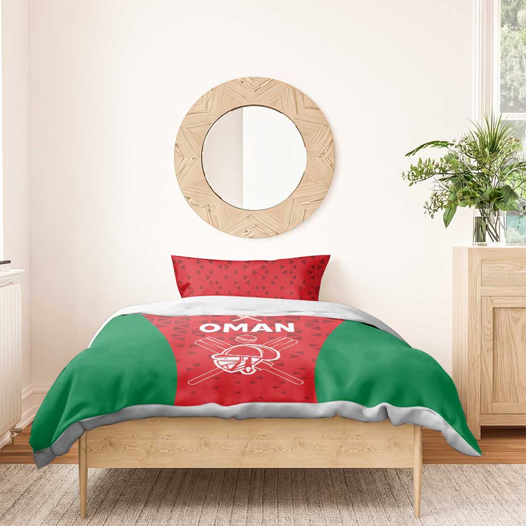 Red and green cricket bedding set with white “OMAN” text on the duvet and matching pillow