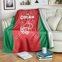 Cricket blanket with red and green design, “OMAN” text and white cricket helmet graphic