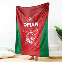 Oman cricket blanket draped display in red and green with white “OMAN” and helmet graphic