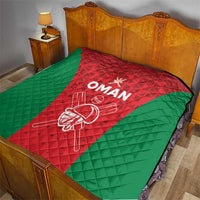Oman cricket quilt on a bed, red center with green sides and white “OMAN” print