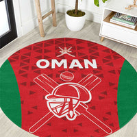 Red round cricket carpet with Oman logo, crossed-bat helmet emblem, green border