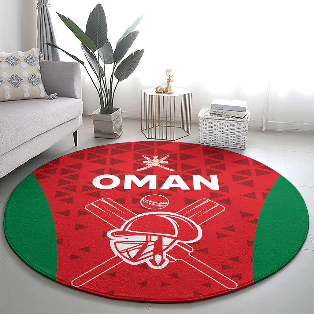 Red circular cricket rug with Oman lettering, cricket helmet emblem, and green edge