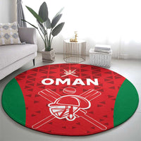 Red circular cricket rug with Oman lettering, cricket helmet emblem, and green edge