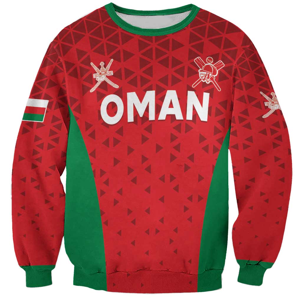 Red crewneck sweatshirt with green trim, geometric pattern, OMAN graphic and cricket icons