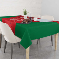 Oman cricket tablecloth on table, red printed panel with green border and helmet logo