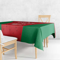 Oman cricket tablecloth with red corner panel and green side panels, folded over table edge