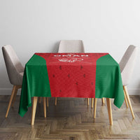 Oman cricket tablecloth on rectangular table, red center with green sides and “OMAN” graphic