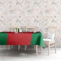 Oman cricket tablecloth on dining table, red center with green border and cricket helmet motif