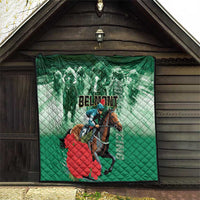 Green quilt hanging on wall, diamond stitching with horse rider graphic and 'BELMONT' text