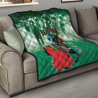 Green horse racing quilt folded on a sofa, with rider and horse graphic and 'BELMONT' text