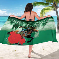 Green Belmont horse racing sarong with jockey graphic, worn with back tie