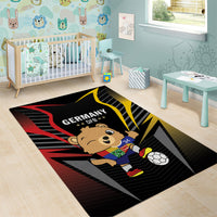 Black football area rug with Germany DFB bear mascot holding soccer ball, red/yellow rays