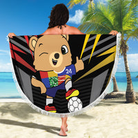 Round beach blanket showing black Germany DFB bear graphic with white fringe