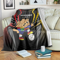 Black blanket draped on sofa, Germany DFB logo with cartoon mascot and soccer ball