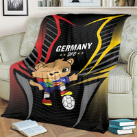 Black football blanket on couch, Germany DFB print and cartoon mascot with soccer ball