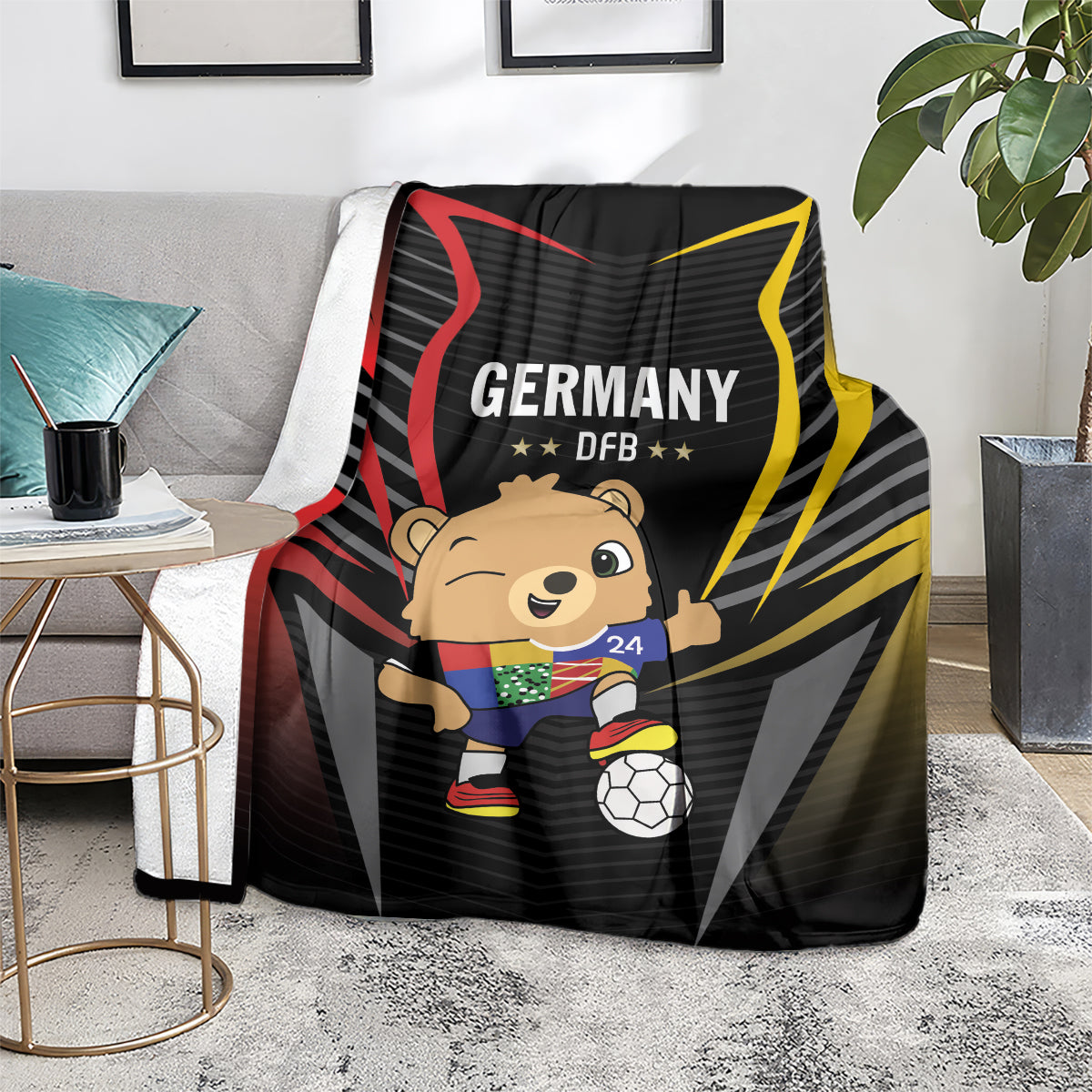 Black football blanket on floor, Germany DFB graphic with cartoon mascot and soccer ball