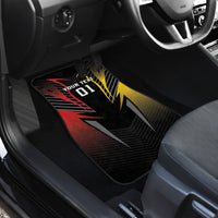 Close-up black floor mat with bold red, yellow, and gray geometric graphic and chevron base