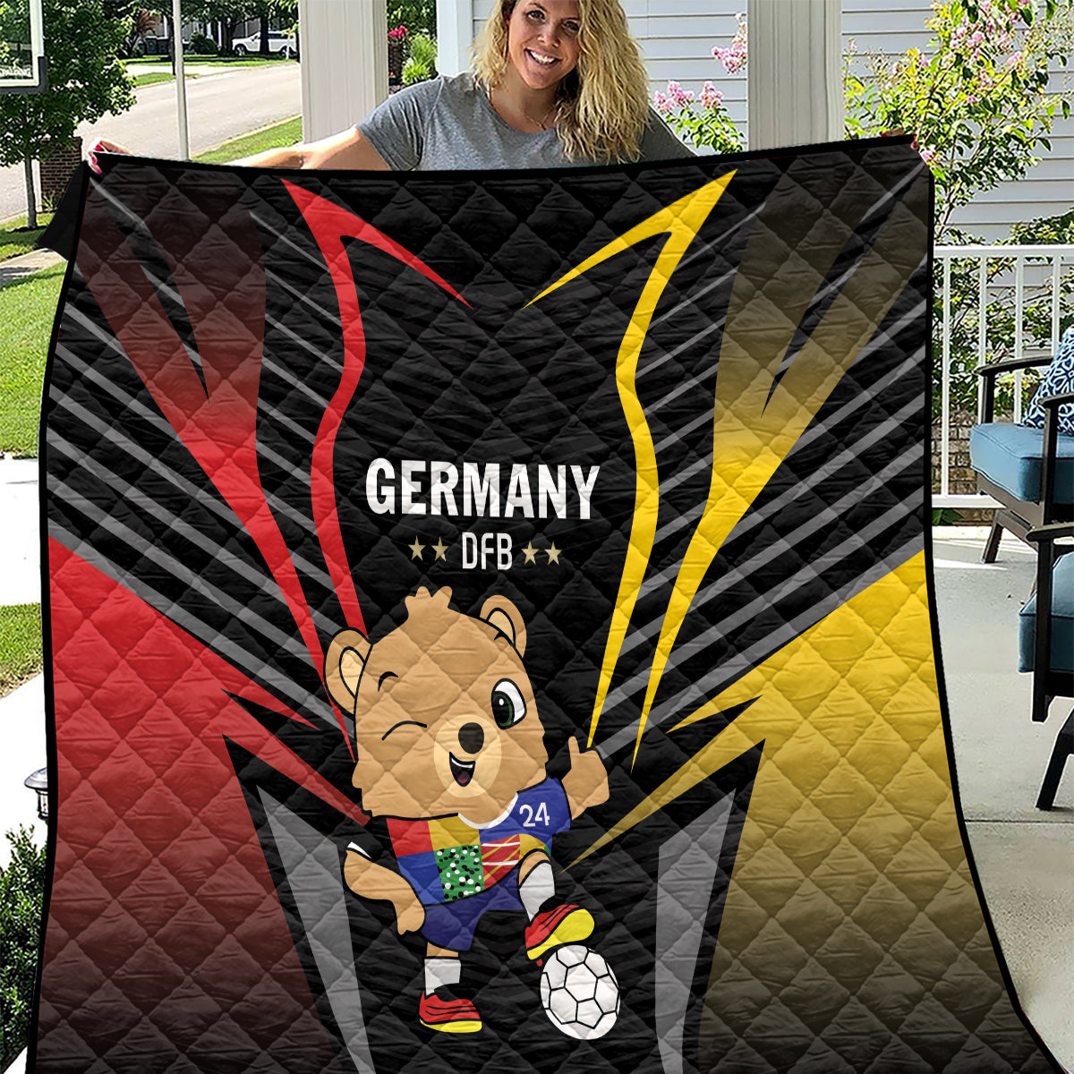 Black quilt featuring Germany DFB emblem, bear mascot, soccer ball, red and yellow rays