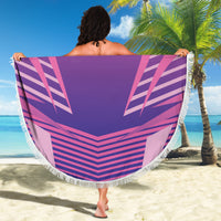 Pink fringed round beach blanket with Germany DFB crest, held up on a sandy beach