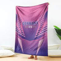 Hanging pink and purple Germany DFB football blanket with large crest and star details.