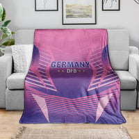 Pink and purple Germany DFB football blanket draped on a couch, showing central team emblem.
