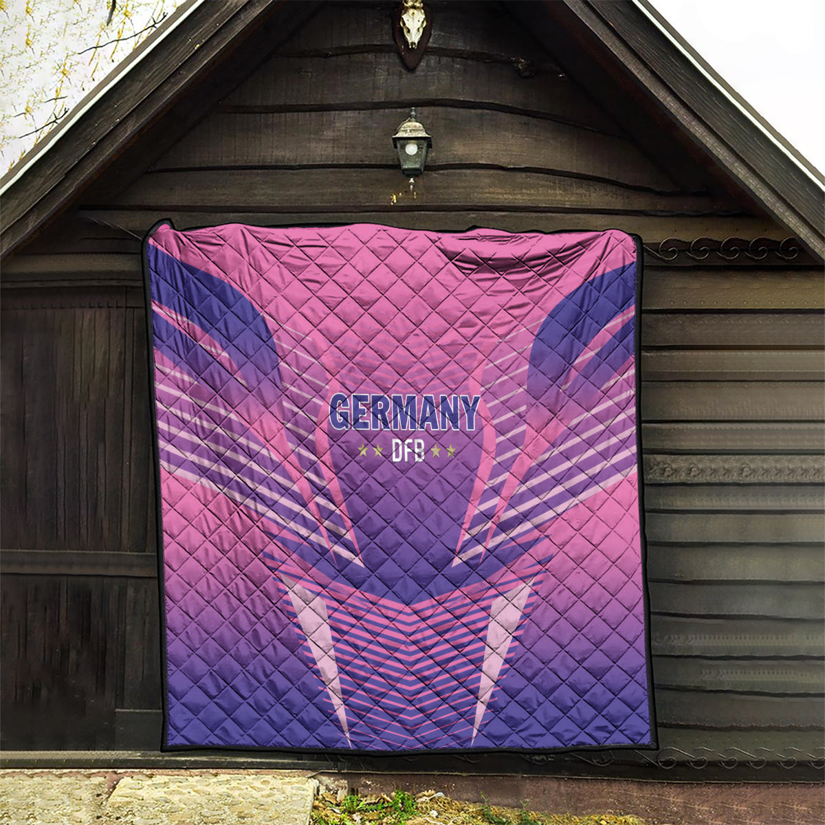 Pink and dark blue Germany 2024 football quilt with DFB lettering and graphic center