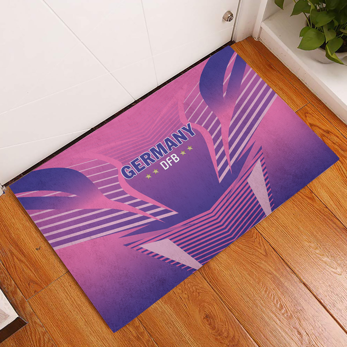 Pink football rubber doormat with Germany DFB logo and blue geometric streak pattern