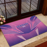 Pink football rubber doormat with Germany DFB emblem and purple fan-like stripes