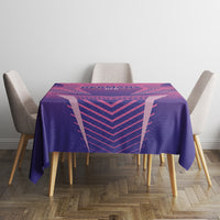 Purple football tablecloth with pink geometric lines on a dining table and two beige chairs