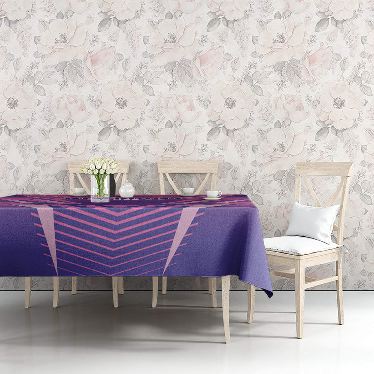 Purple and pink football tablecloth on a dining table with flowers and vases on top