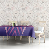 Purple and pink football tablecloth on a dining table with flowers and vases on top