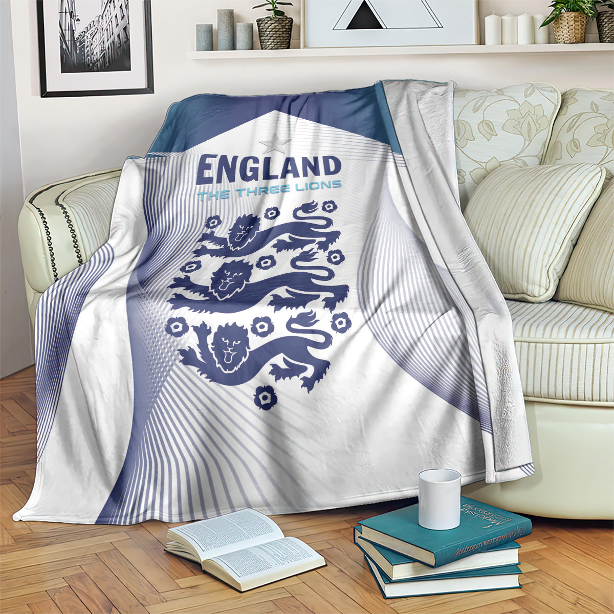 Blue and white England football blanket with Three Lions crest graphic, draped over couch