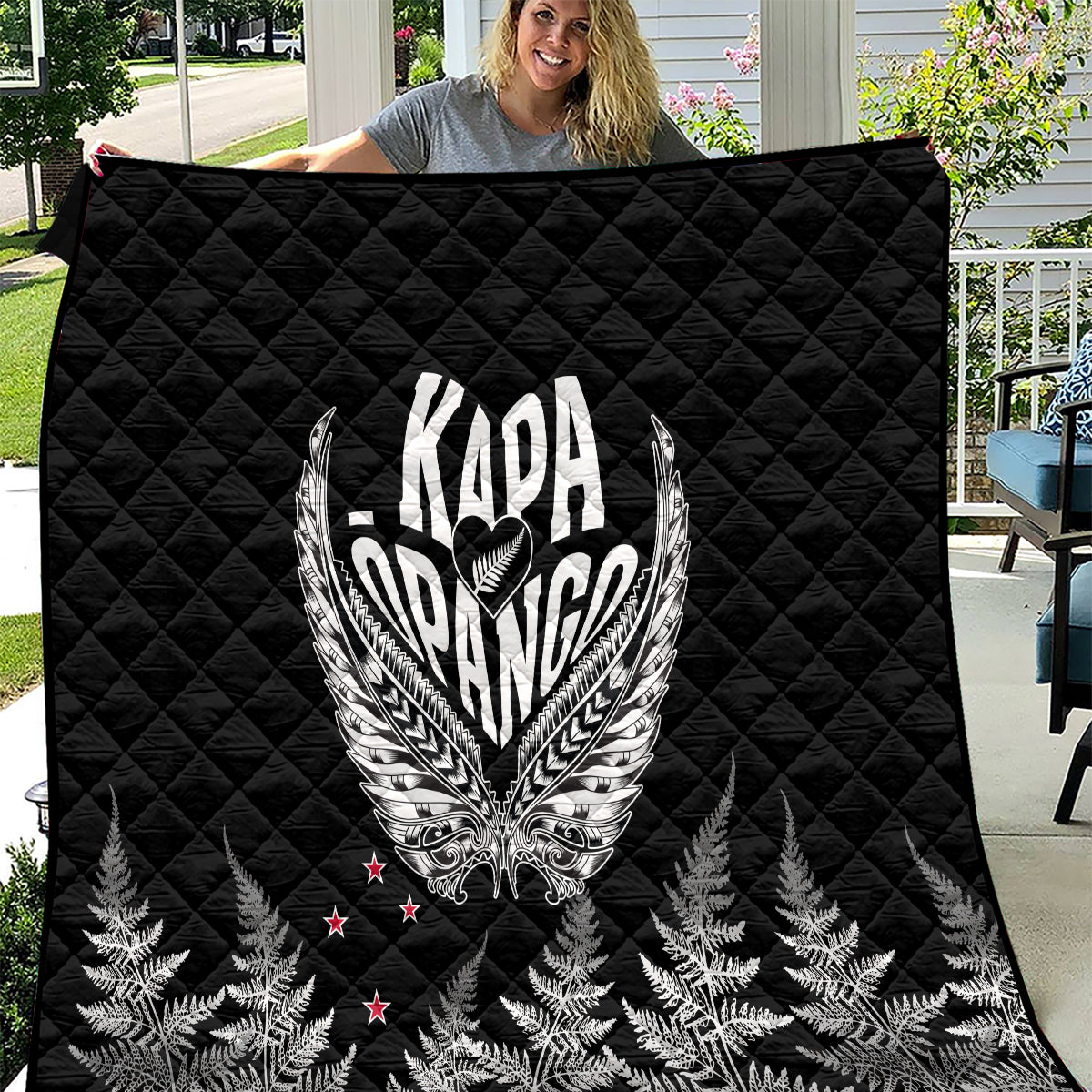 Black quilt with silver-toned Kapa Opango crest and fern pattern, quilted diamond texture