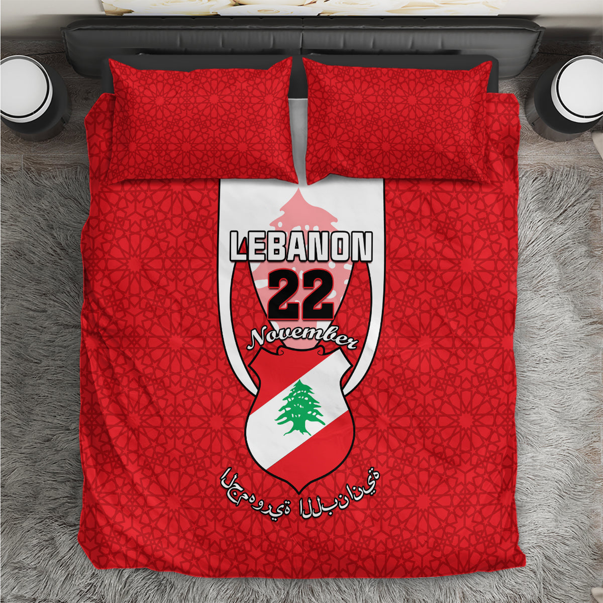 Red bedding set with patterned fabric, two matching pillows, and central Lebanon crest