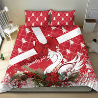 Red Christmas bedding set with bow center, swan image, and holiday tree accents