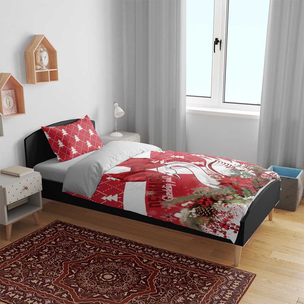 Red and white Christmas bedding set on bed, featuring bow and swan artwork