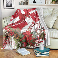 Red and white Christmas blanket with bow, swan, and holiday florals at the center