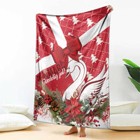 Red and white Christmas blanket featuring a large bow and swan graphic with florals