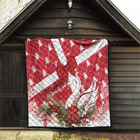Red and white quilt laid flat with star center, swan feathers, and winter florals