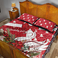 Red and white Christmas quilt with swan curve design and bow ribbon, styled on bed