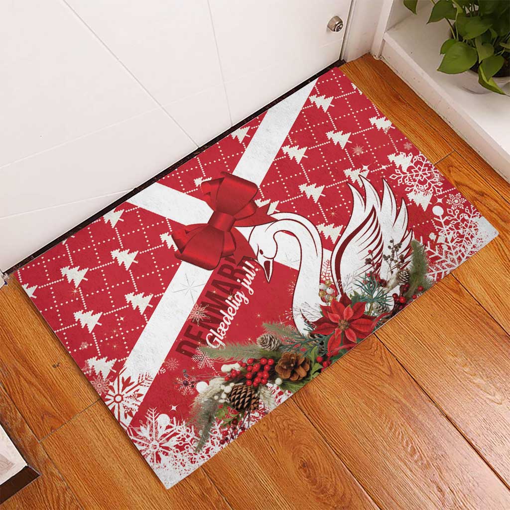 Red Christmas rubber doormat with white swan and red bow over diagonal stripe