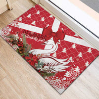 Red rubber doormat with white swan, red bow, and red-and-white holiday print