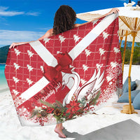 Red and white holiday sarong with swan print and coquette bow detail, draped.