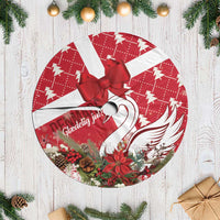 Red and white round tree skirt with large red bow, fringe trim, holiday swan design