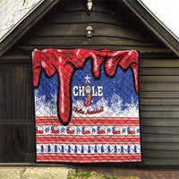 Chile Christmas quilt displayed indoors/outdoors on a wall with red, blue, and white patterns