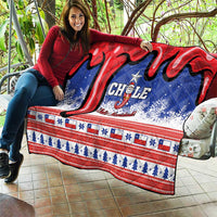 Chile Christmas quilt laid out outdoors with red and blue swirls, stars, and striped border