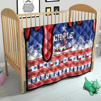 Chile Christmas quilt on a baby bed/crib with red-blue snowflake stripes and “Chile” text