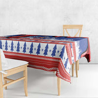 Blue Christmas tablecloth laid across small table with red trim and star icons
